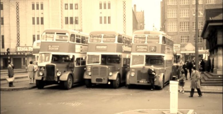 The Bus terminus with three classic buses awaiting their passengers with Elvis Presely appearing on screen at The Plaza